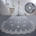 Long lace wedding veil in white made of delicate lace with intricate floral embroidery and beaded accents along the hem