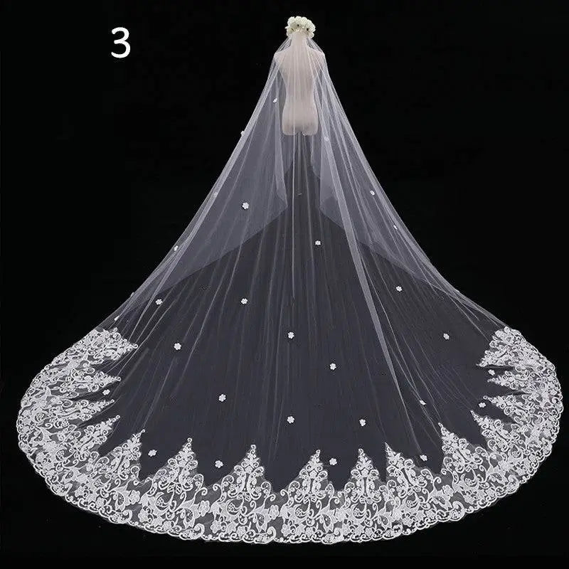 Long lace wedding veil in white lace with intricate floral embroidery and scattered pearl embellishments meters wide