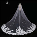 Long lace wedding veil in white with intricate floral embroidery and delicate lace featuring a floral cluster top adornment