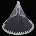Long lace wedding veil meters wide with delicate white lace and intricate floral embroidery draped over a mannequin
