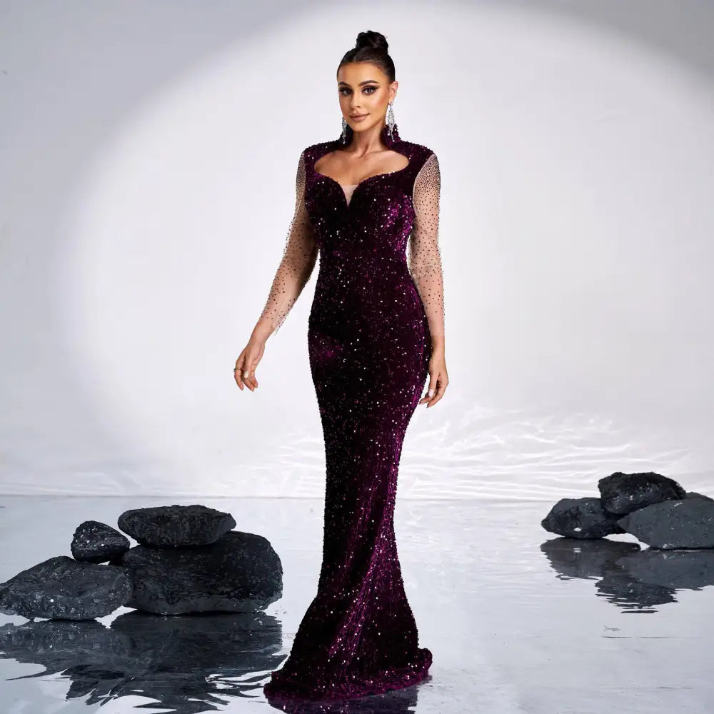 A deep purple sequined rhinestone fishtail gown with long sheer dotted sleeves for elegant banquet wear