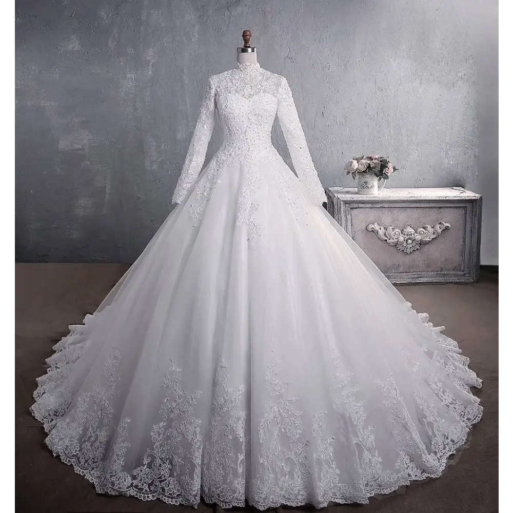 A white long sleeve lace wedding dress with intricate lace detailing, high neckline, and a large tail bridal gown