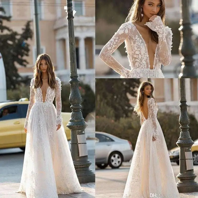 A delicate white long sleeve wedding dress lace gown with a deep v neckline and flowing skirt