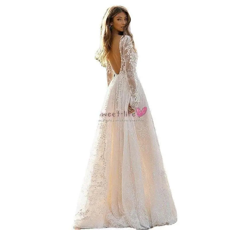 Elegant white wedding dress lace gown with long sleeves and deep back cutout showcasing delicate white long lace details