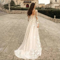 Back of an ivory lace wedding dress mori style featuring long sleeves and intricate floral lace on sheer tulle fabric