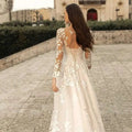 A delicate ivory lace long sleeve wedding dress mori style featuring an intricate floral pattern