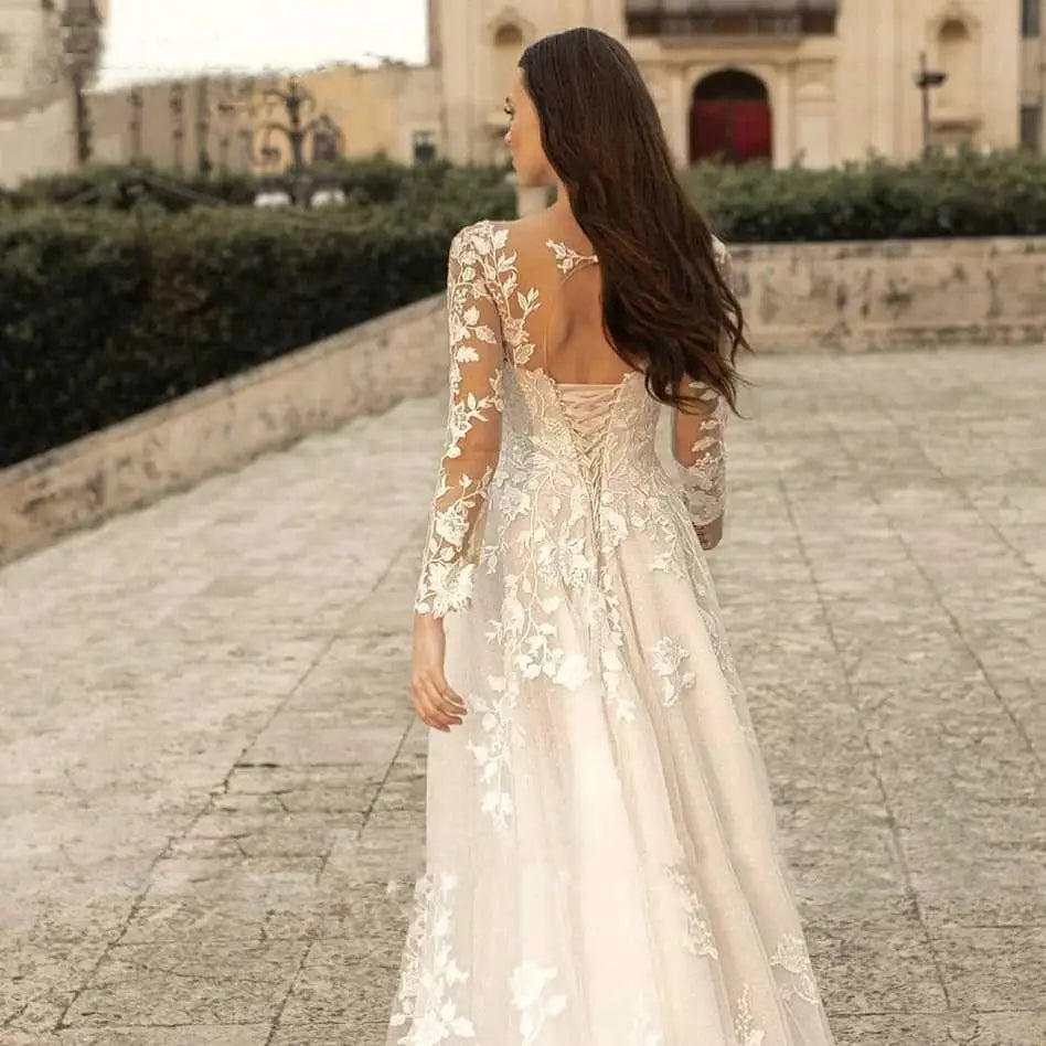 A delicate ivory lace long sleeve wedding dress mori style featuring an intricate floral pattern