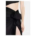 Black satin wrap skirt with prominent bow at the waist paired with black long sleeved elastic shoulder dress featuring hollow slit