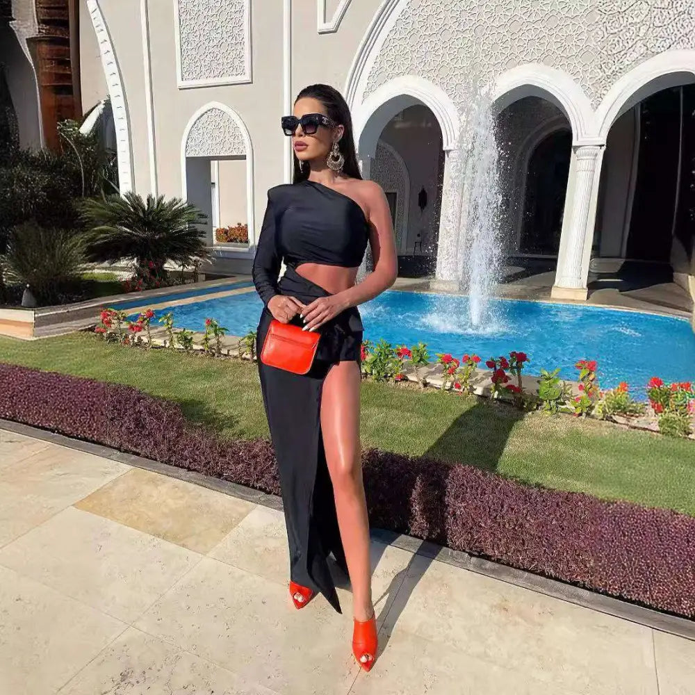 Vibrant orange mini crossbody bag with a sleek structured design and smooth leather finish paired with black long sleeved elastic shoulder dress with sleeved hollow slit