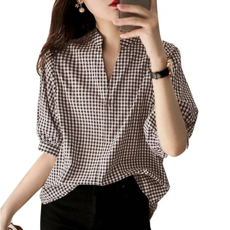 Loose casual half sleeve plaid v neck blouse in black and white checkered pattern with relaxed fit and three quarter sleeves