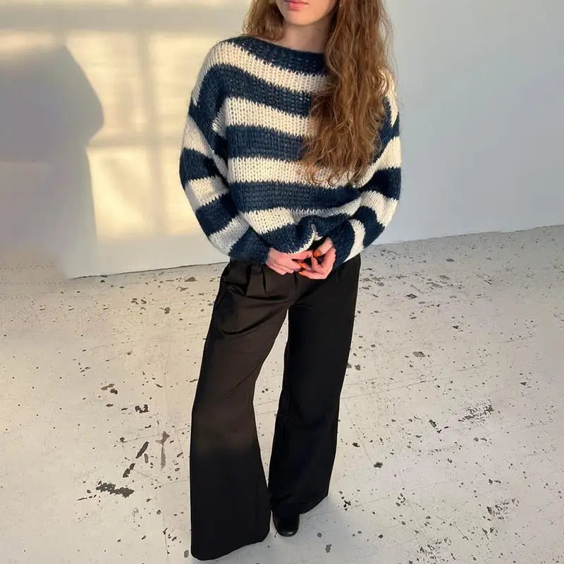 Navy and white horizontally striped knit loose pullover sweater for women with a cozy loose striped design