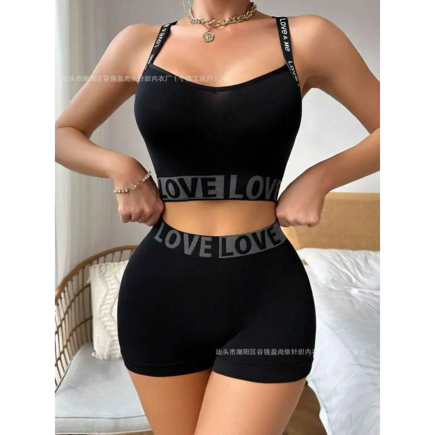 Black love letter camisole and leggings set with love lettering on waistband and straps in athletic two-piece design