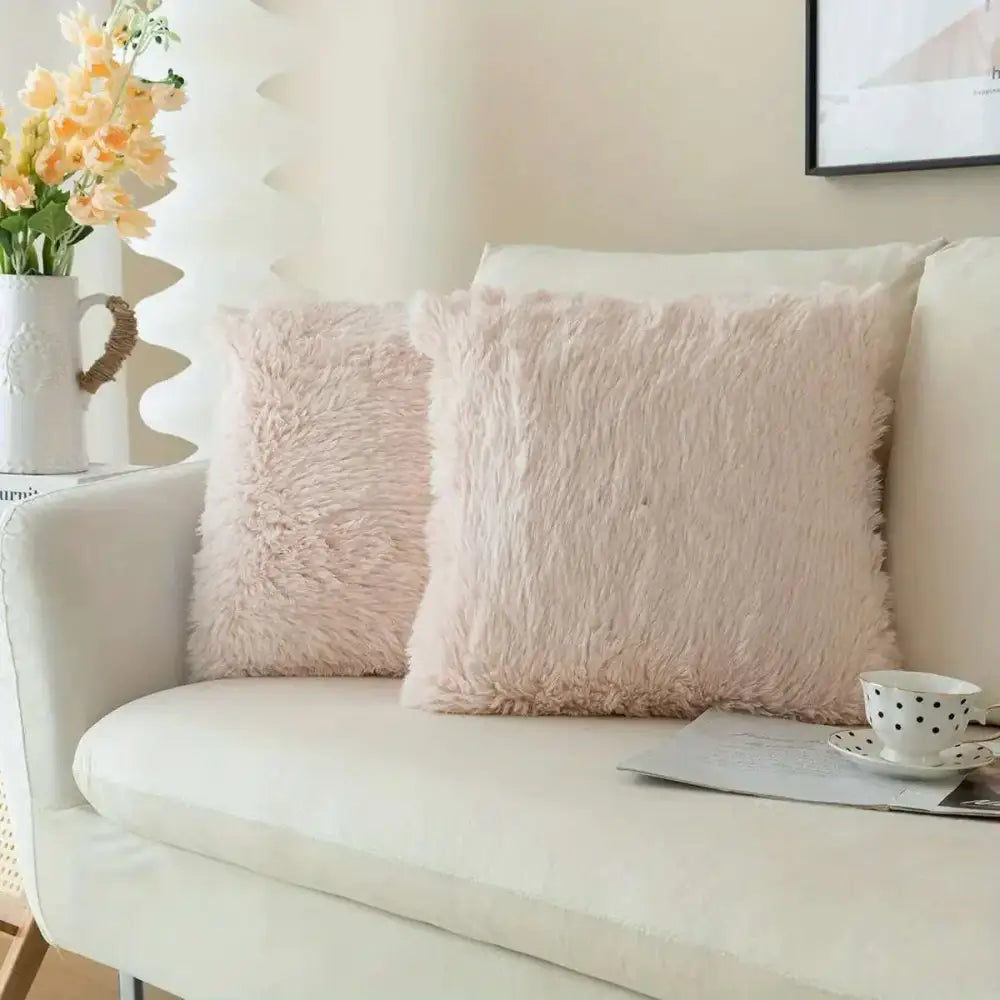 Luxurious soft faux blush pink fur throw pillow covers with plush textured surface for elegant cushion decor