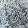 A luxurious soft faux gray fur throw pillow cover with a plush fluffy textured surface for decorative cushions