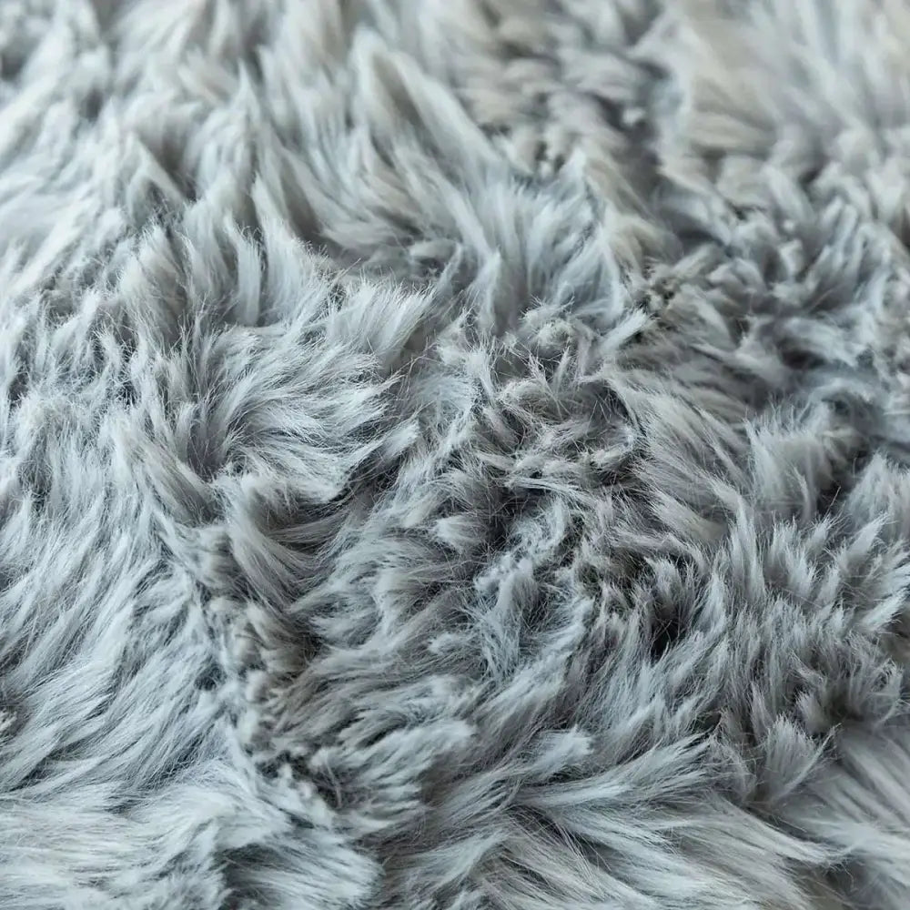 A luxurious soft faux gray fur throw pillow cover with a plush fluffy textured surface for decorative cushions