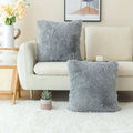 Two plush light gray luxurious soft faux fur throw pillow covers with a soft fluffy texture for cushion covers