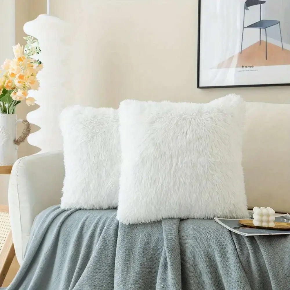 Luxurious soft faux fur throw pillow cushion covers in white with a fluffy plush texture for home decor