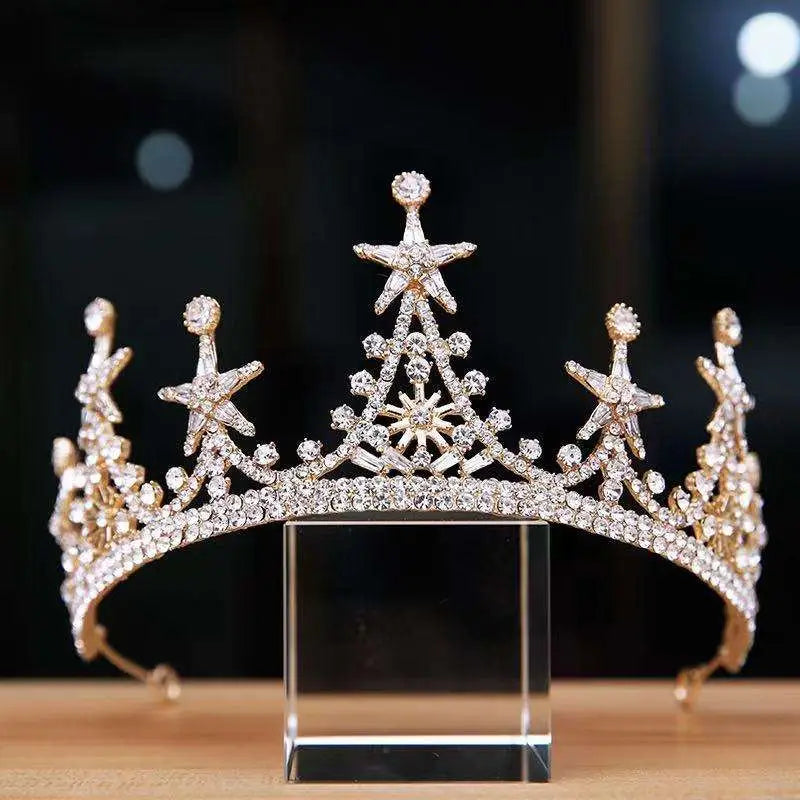 Luxury atmosphere bridal crown in gold adorned with clear crystals and intricate star-shaped embellishments