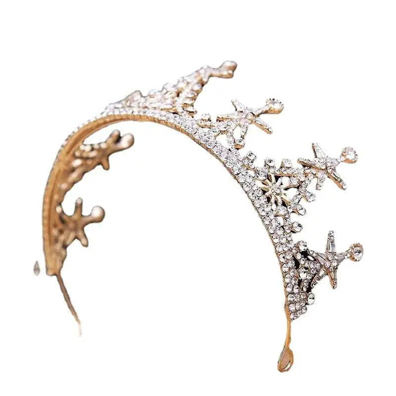 A luxury atmosphere bridal crown in gold tone with clear crystals and intricate star embellishments for weddings