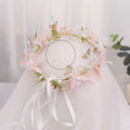 Delicate pink and gold floral bridal wreath with gold butterfly charms pearls and light blue beads for bridal wear