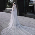 A luxury heavy industry bridal pearl veil in white adorned with scattered pearl-like beads and a sparkling tiara