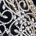 Luxury rhinestone bridal crown in gold tone featuring intricate crystal embellishments and a starburst accent