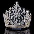 A sparkling gold bridal crown with intricate crystal embellishments and a central diamond starburst accent