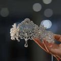 A luxury silver forehead crown with intricate crystal rhinestones and pearl embellishments for rhinestone wedding dress