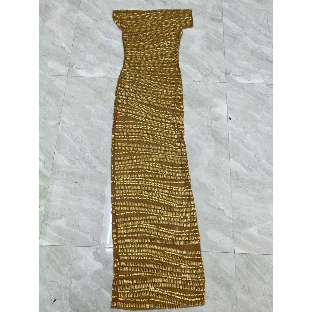 A luxury shiny rhinestone gold beaded off-the-shoulder maxi dress with a textured ribbed knit pattern