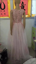 A luxury women’s fashion pink lace wedding dress with fitted bodice and flowing tulle skirt ideal for elegant occasions