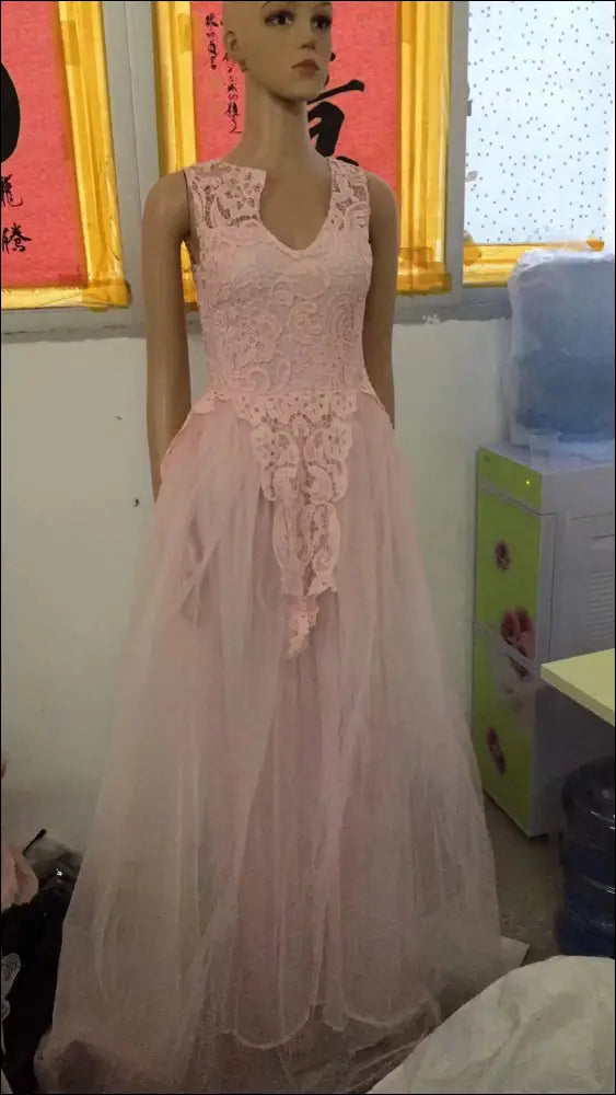 Luxury women’s fashion delicate pink floral lace wedding dress with v-neckline and layered tulle skirt on mannequin