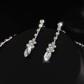 Elegant silver-toned earrings set featuring sparkling clear crystals in a floral pattern for luxury women’s fashion