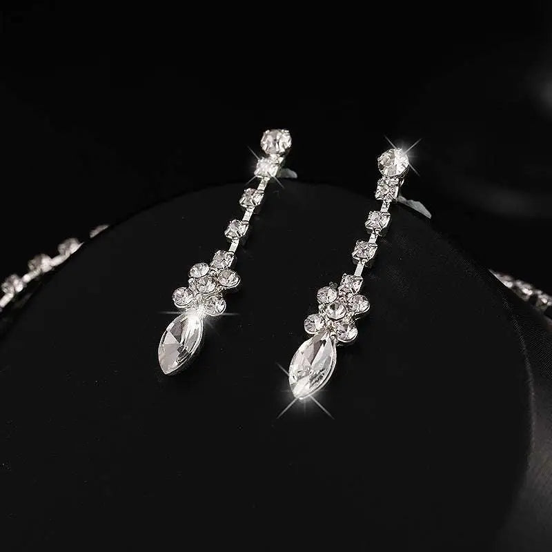Elegant silver-toned earrings set featuring sparkling clear crystals in a floral pattern for luxury women’s fashion