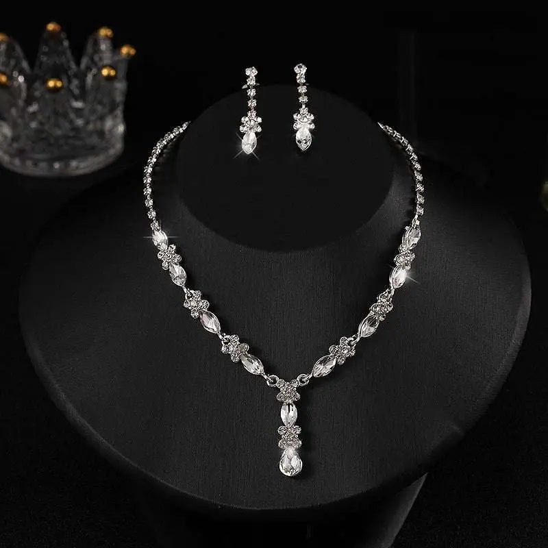 A luxury zircon necklace and earrings set with a sparkling silver floral design and dangling teardrop crystals