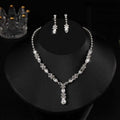 A luxury zircon necklace and earrings set with a sparkling silver floral design and dangling teardrop crystals