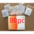 A box of 80pc magnetic slimming belly button patch weight loss patches with orange white design and clear packaging