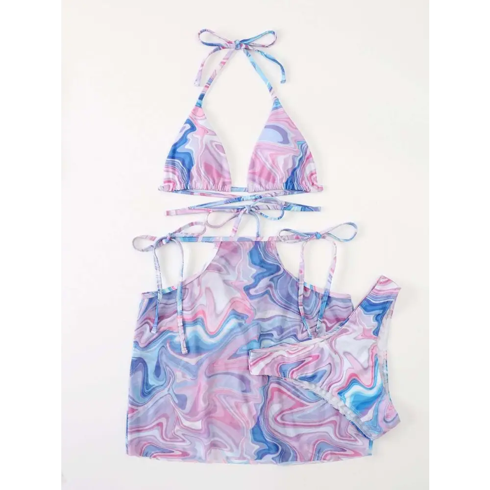A marbled pink and blue bikini 3-piece beach skirt set with a vibrant abstract halter top and matching cover-up