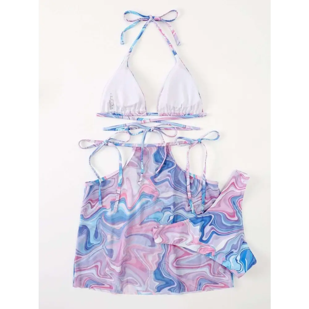 A vibrant bikini 3-piece beach skirt set with a marbled pink and blue abstract pattern featuring a halter top and skirt