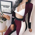 Maroon and white dual-shade athleisure set featuring a color-blocked sportswear jacket with black trim for activewear use
