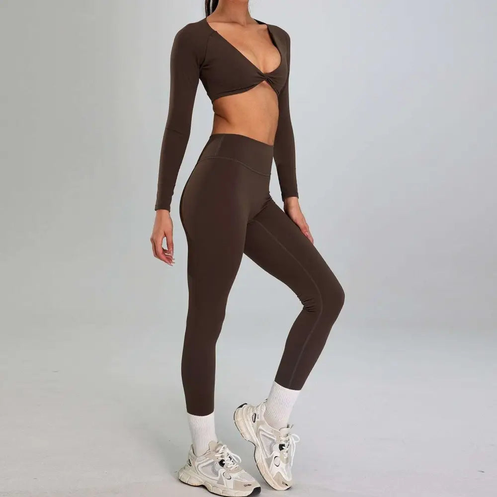 A solid brown high waist suit two-piece sports suit outdoor with long-sleeved crop top and twisted front detail