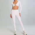 White long-sleeved crop top with twisted front and matching high waist leggings in a running nude set for outdoor sports