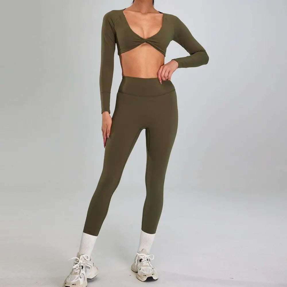 Olive green long-sleeved crop top with twisted front and matching high waist leggings in a running nude set