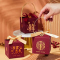 Maroon minimalist wedding candy gift boxes with gold Chinese characters bows and a gold handle for fashion simple gifting