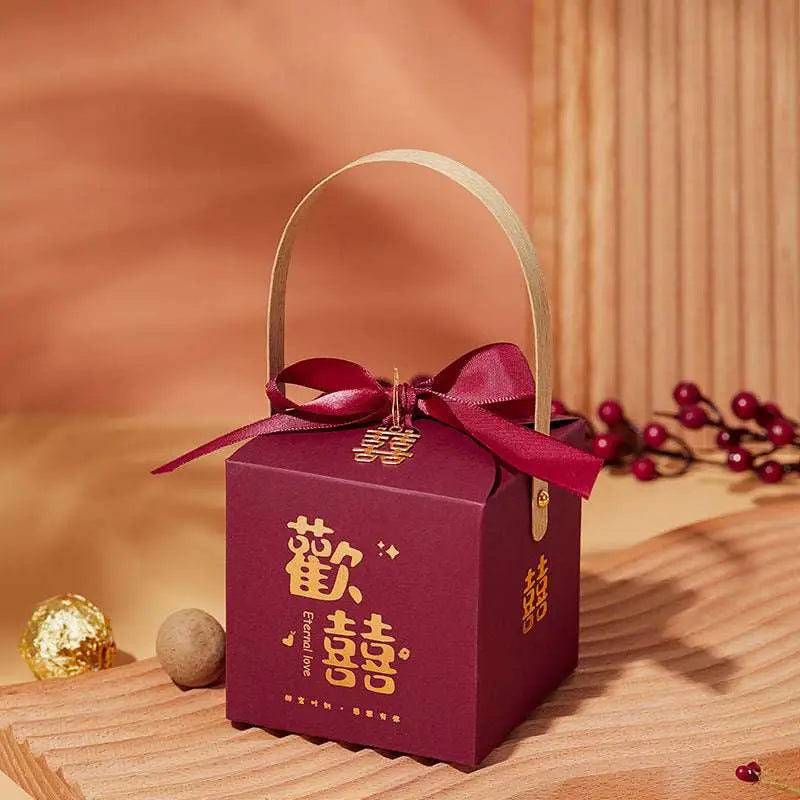 Maroon minimalist wedding candy gift box with gold Chinese characters, ribbon bow, and a light wood handle