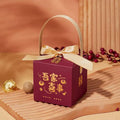 Maroon minimalist wedding candy gift box with gold satin ribbon bow handle and golden chinese decorative motifs