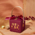 Maroon minimalist wedding candy gift box with gold chinese characters, matching ribbon bow, and light wood handle