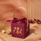 Maroon minimalist wedding candy gift box with gold chinese characters, matching ribbon bow, and light wood handle