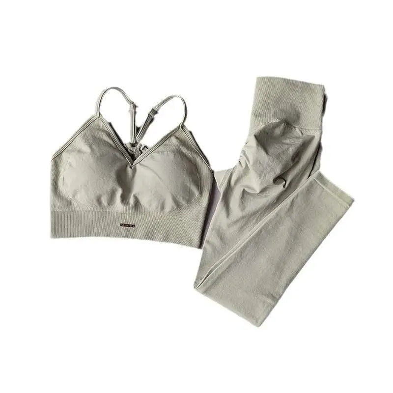 A sleek light gray sports high waist tight seamless two-piece set with a supportive bra top and stretchy leggings