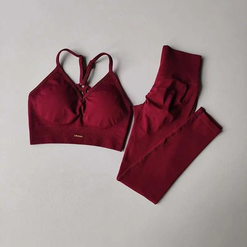Maroon sports high waist tight seamless two-piece set with crisscross bra straps and tight seamless leggings