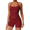A maroon two piece workout set for women featuring a halter top and high waist stretchy gym shorts